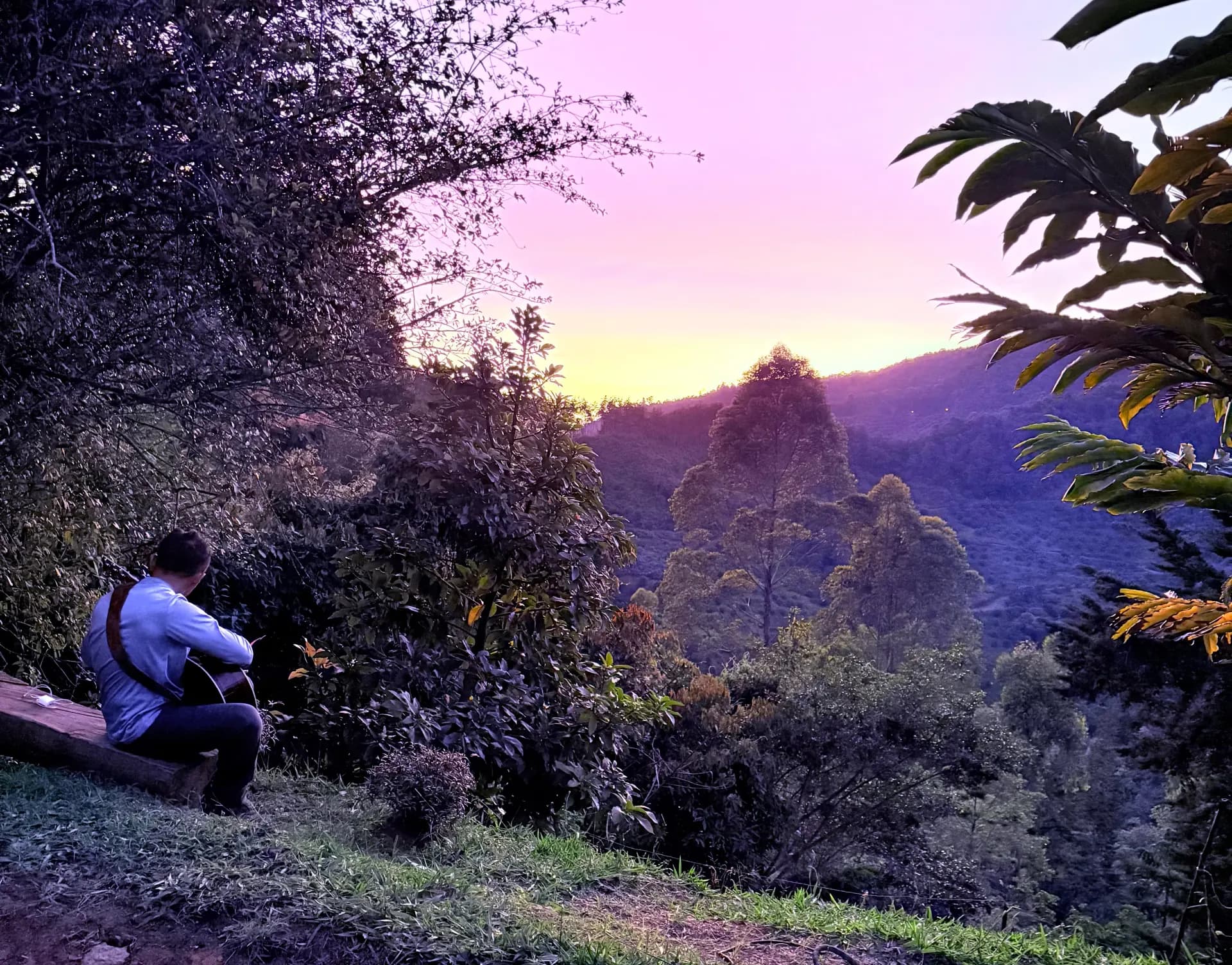 A guest sitting quietly at sunset in the Antioquia mountains