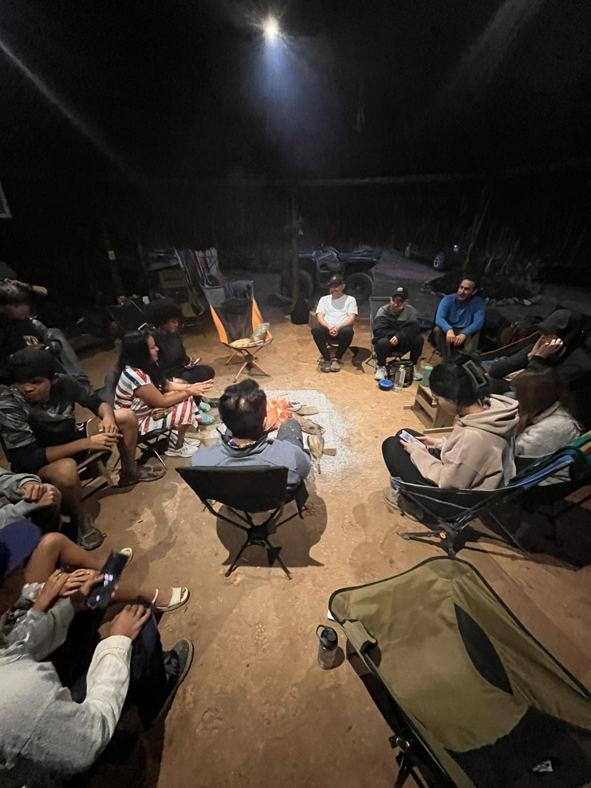 Guests gathered in a circle around the fire at night in Yaogara