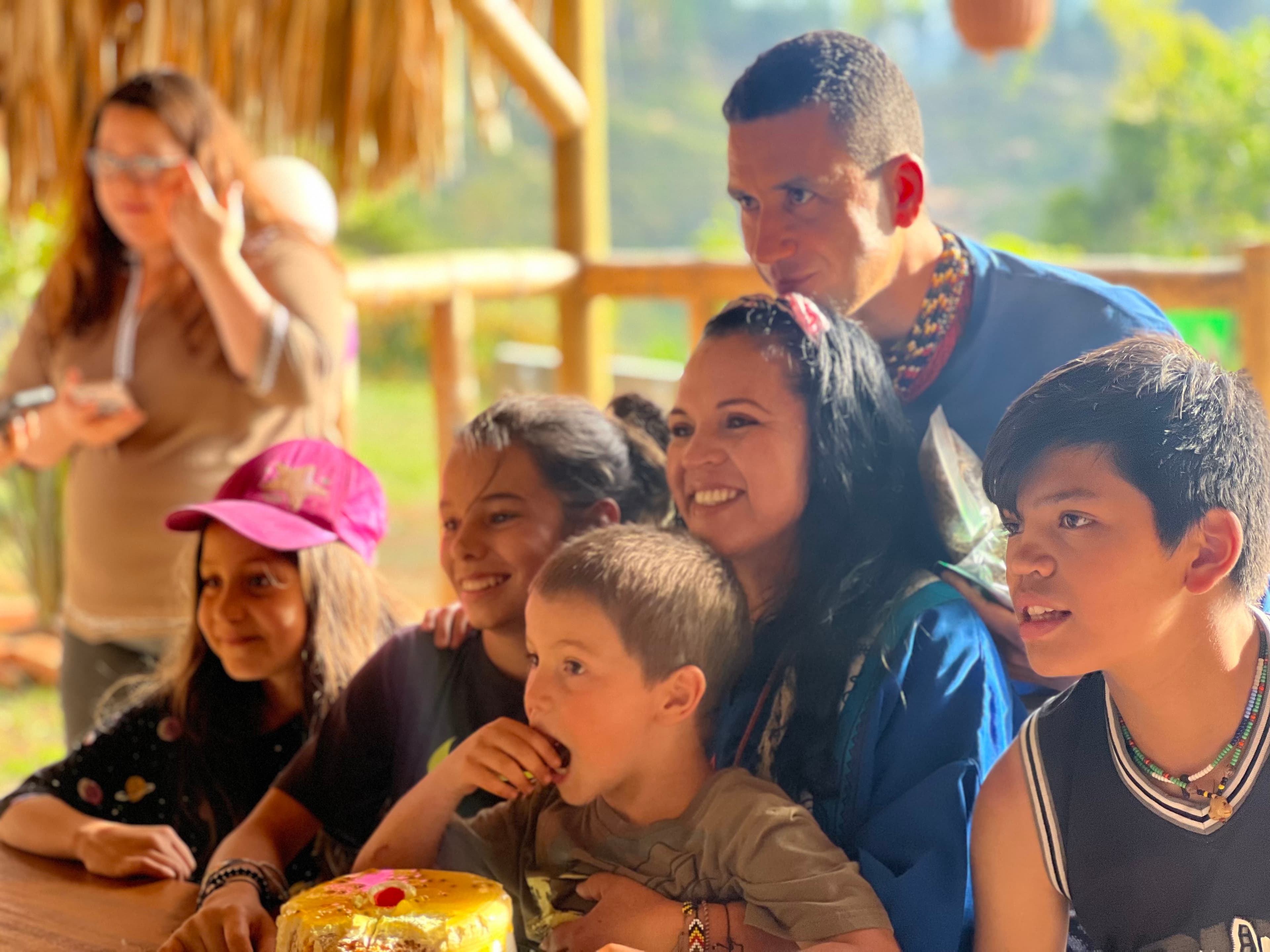 Family gathered together under the bohio at Yaogara